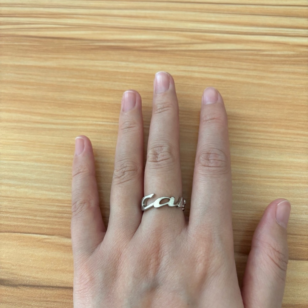 Cartier 18k white gold signature ring with 3 diamonds.